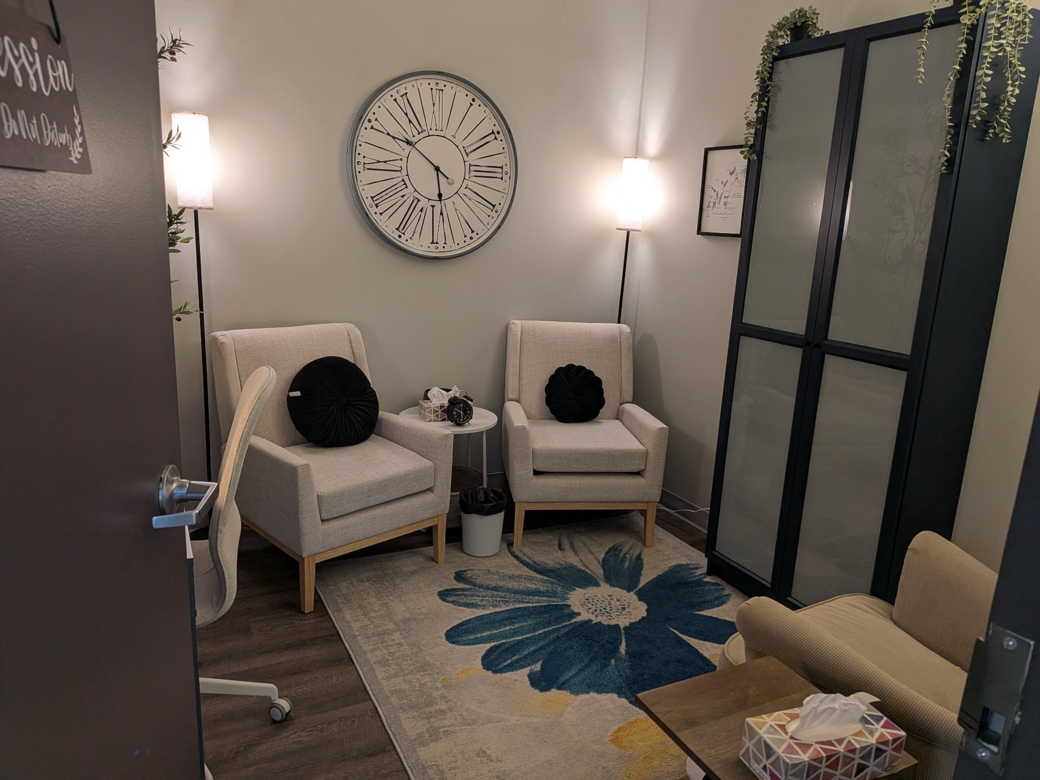 Quiet private therapy room with two armchairs and soft lighting